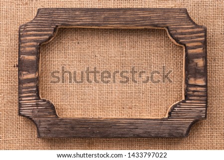 Wooden blank frame with on burlap. Top view. Copy space