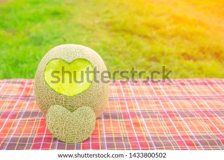  cantaloupe or green melon with shape heart for love and takecare concept.valentine background.