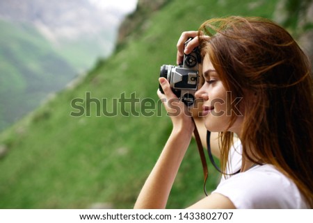 woman photographs on camera beauty of nature mountain