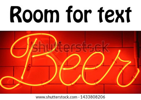 Neon Beer Sign. Orange or Red Neon BEER Sign on a white tile wall. Beer Sign. Neon Sign. 