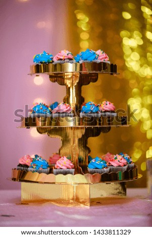 Cup cakes decorated for Gender Reveal Party. Blue and Pink colored cup cakes - Image