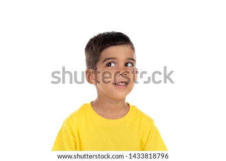 Pensive child with yellow t-shirt isolated on a white background