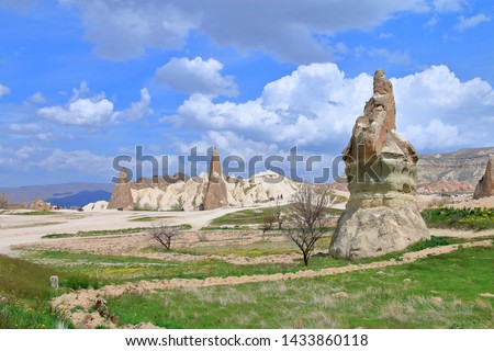 The photo was taken in Turkey in the spring. The picture shows the beautiful landscapes found on the mountain trails of Cappadocia. Also in the picture you can see people on horseback riding.