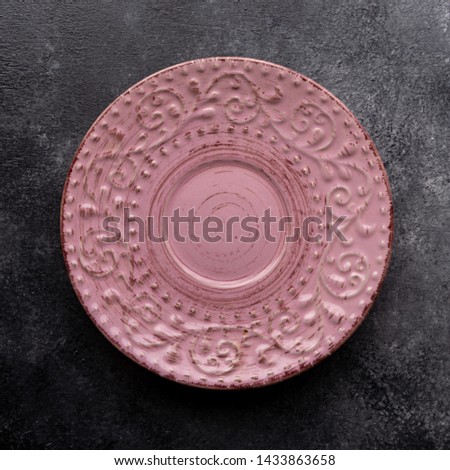 Picture of a pink plate on a table