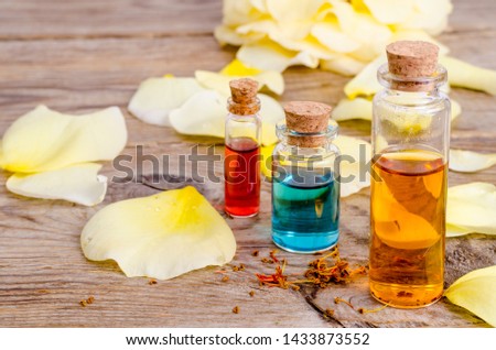Glass bottles of aroma essential oil on wooden background, image for alternative therapy medicine. Studio Photo