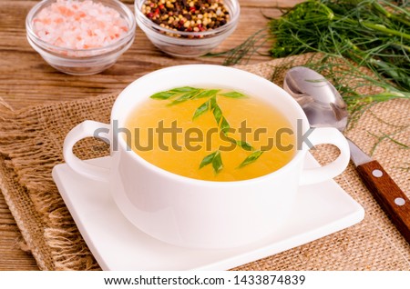 Chicken broth soup in white plate. Studio Photo