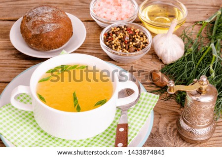 Chicken broth soup in white plate. Studio Photo