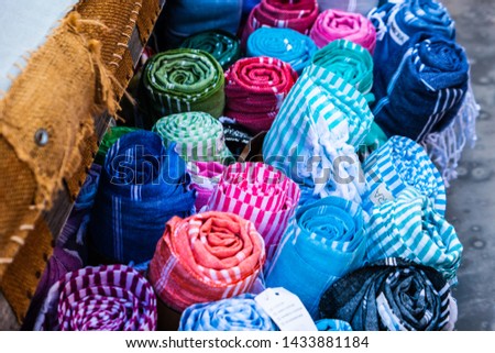 rolls of colored cloth, strolling through the Greek streets