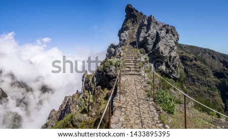 Hiking trail through inland mountains from the Pico de Ariero to Pico Ruivo. Madeira, Portugal. Royalty-Free Stock Photo #1433895395