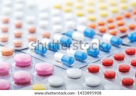 Heap of medical pills in white, blue and other colors. Pills in plastic package. Concept of healthcare and medicine. Royalty-Free Stock Photo #1433895908