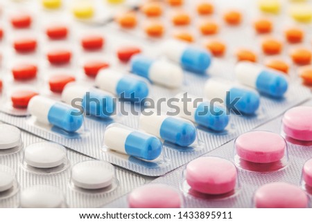 Heap of medical pills in white, blue and other colors. Pills in plastic package. Concept of healthcare and medicine. Royalty-Free Stock Photo #1433895911