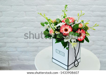 Beautiful bouquet of flowers in a vintage box on white table for wedding