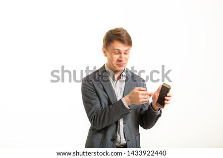 Funny man in a jacket, on a white background. Smart guy with a funny facial expression. Busy businessman humor makes selfie