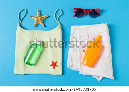 Flat lay composition with Beach accessories on blue color background. Summer holiday background. Vacation and travel items top view.