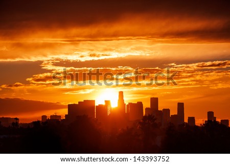 Sun rising over Los Angeles city skyline Royalty-Free Stock Photo #143393752