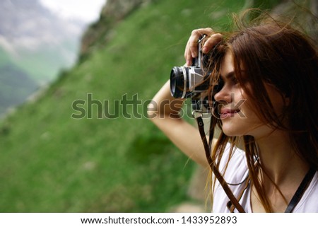 woman holding a camera in nature