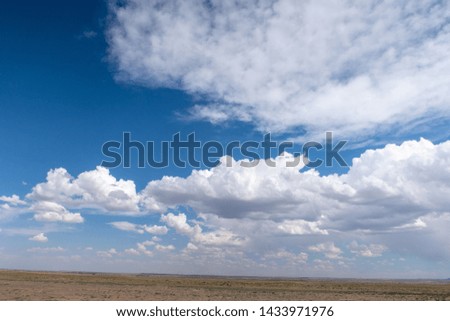 Landscape of bright blue sky and puffy clouds in New Mexico