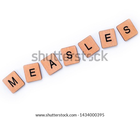The word MEASLES, spelt with wooden letter tiles over a white background. Measles is a highly contagious infectious disease caused by the measles virus.