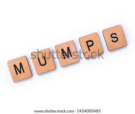 The word MUMPS, spelt with wooden letter tiles over a white background.  Mumps is a contagious viral infection that used to be common in children before the MMR vaccine.