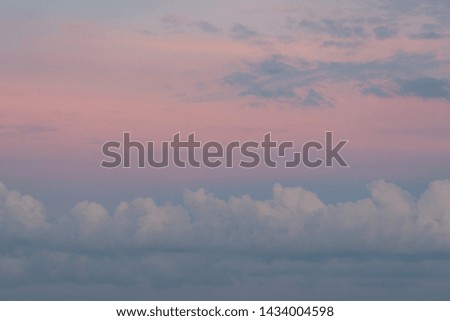 Landscape photo of big, pink cumulonimbus clouds in a stormy sky at sunset. Shot in Montreal, Quebec, Canada. 