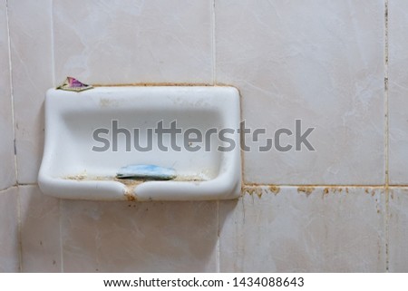 Soap holder filled with dirt in the dormitory bathroom
