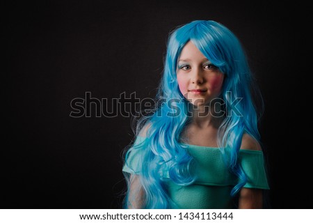 Young beautiful girl dressed in aqua/turquoise with turquoise hair