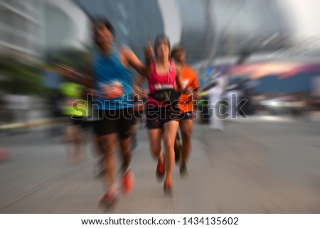 Motion blurred pictures of Marathon Runner against city backgound
