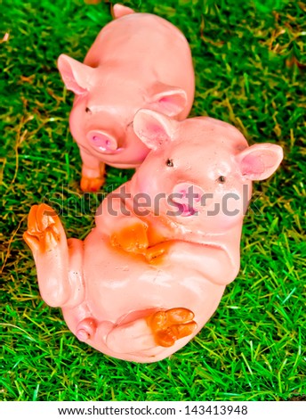 pig clay doll on green