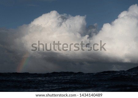 rainbow in moody ocean scene