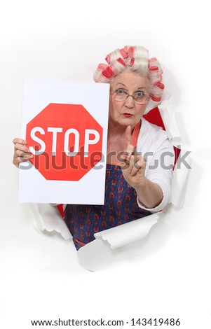 Granny holding a stop sign and with her hair in rollers