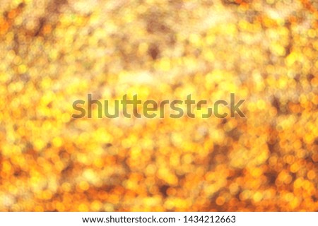 Abstract golden glittering bokeh background. Soft focus, defocused and blurred image.