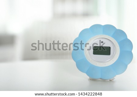 Digital temperature and humidity control in baby room interior. Space for text