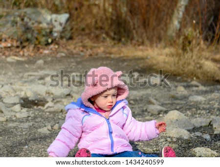 20 months old baby enjoying the nice weather outside. Toddler girl portraits in natural light. Little girl close up pictures in nature, in Winter. Lafarge Lake, Coquitlam, British Columbia, Canada