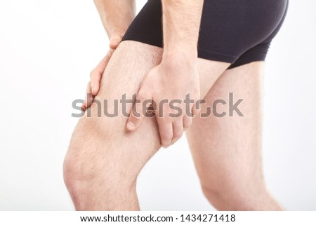 Man muscle strain injury in thigh. Royalty-Free Stock Photo #1434271418