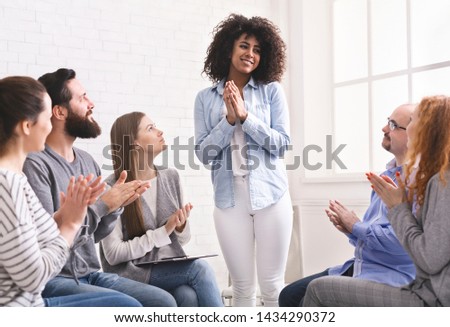Grateful african woman sharing her progress with rehab group at therapy session, empty space Royalty-Free Stock Photo #1434290372