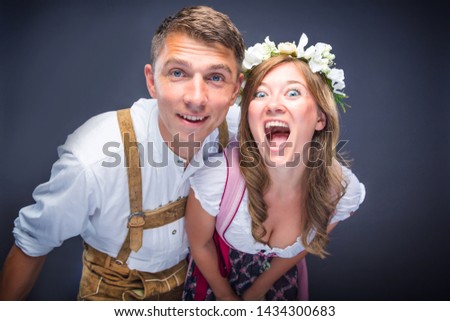 Two friends, men and women having fun in Bavarian Tracht Royalty-Free Stock Photo #1434300683