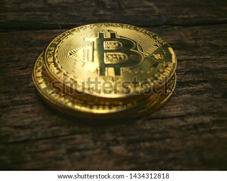 Gold coins with sunshine on a wooden background, warm colors - photos of encrypted coins