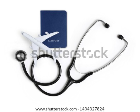 international medical travel insurance concept, stethoscope, passport and airplane isolated on white background Royalty-Free Stock Photo #1434327824