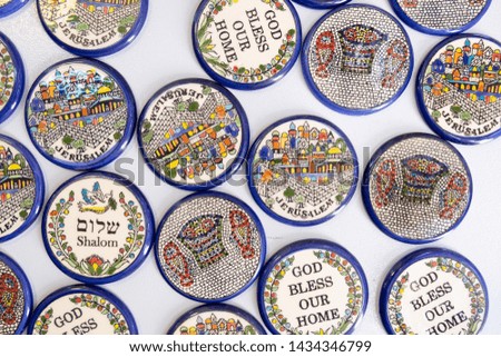 Magnet small plates with "Shalom" (Peace) and other Israel symbols sale at Carmel Market, Tel-Aviv. Israel