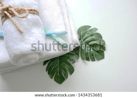 Set with toothbrushes and white towels on table