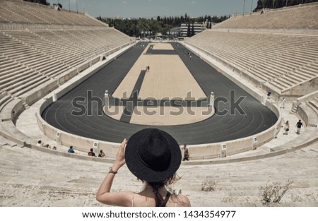 Travel concept - woman or girl with hat looking the Ancient Athens monuments in a sunny day - greece