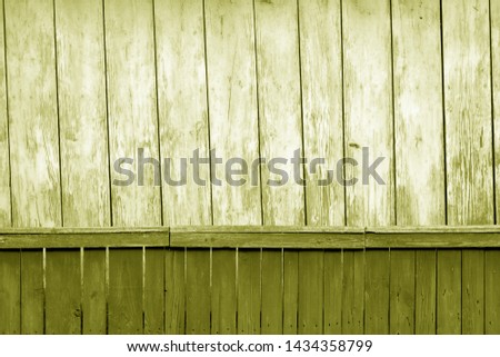 Old grunge wooden fence and wooden wall pattern in yellow tone. Abstract background and texture for design.