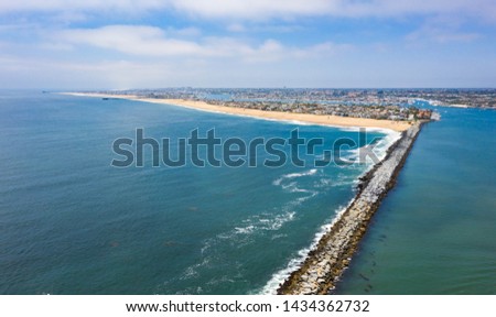 View of the Wedge down the seawall of Newport Beach Harbor