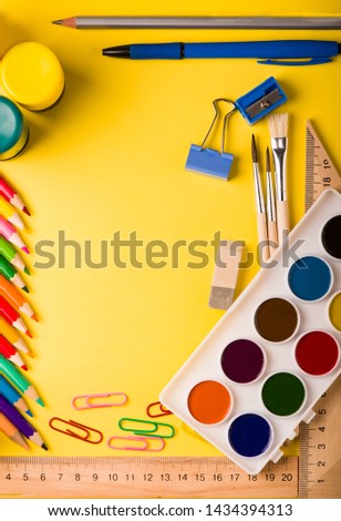 school supplies at abstract colorful background texture.