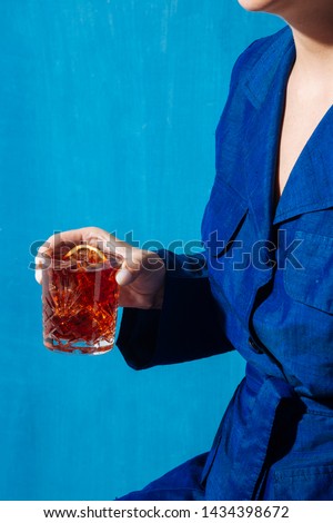 Woman and Negroni cocktail, with gin, bitter and vermouth. Colorful and trendy. Royalty-Free Stock Photo #1434398672