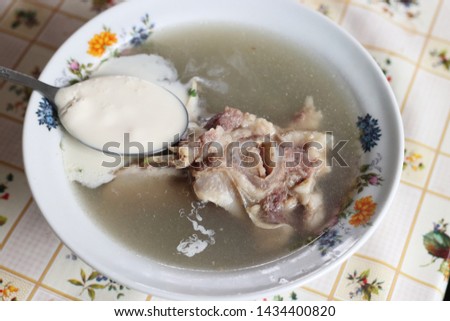 Delicious nettle soup with cream sauce and lamb meat. Healthy food made from natural products.
