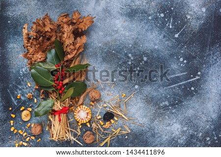 Traditional Christmas decoration in Serbia called Badnjak, Oak branch on rustic blue  surface. Top view, blank space, vintage toned image 