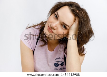 Young beautiful girl posing on white background. Emotions and gestures.