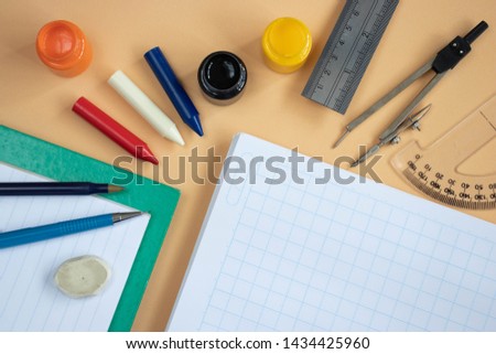 School supplies on a beige background