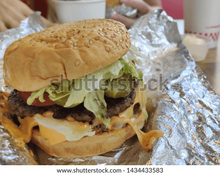 Big hamburger with foil paper